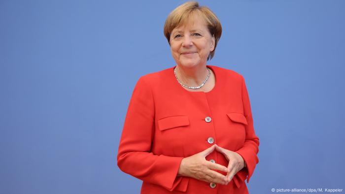 Merkel & her signature diamond gesture