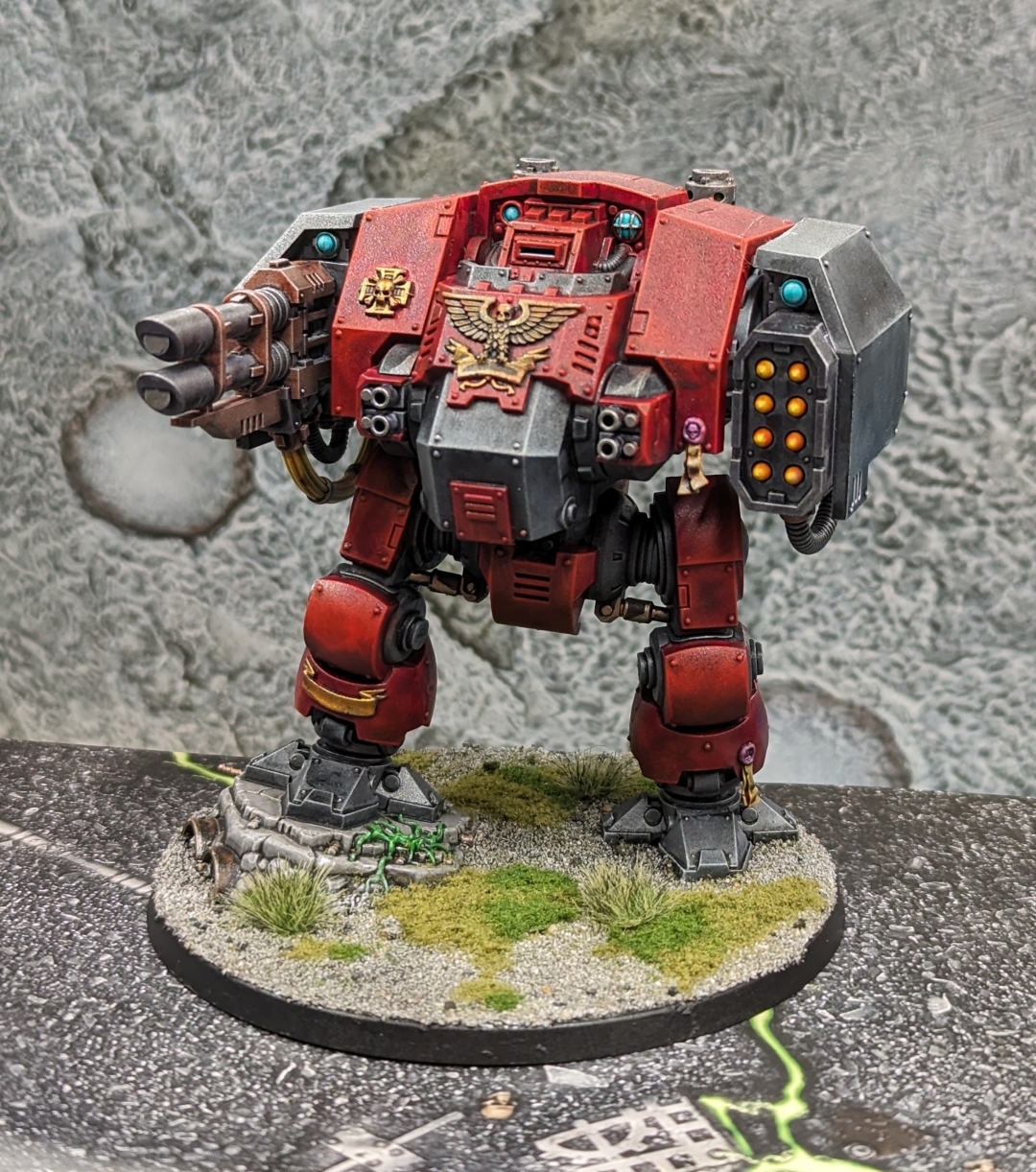 Warhammer 40k Space Marine Dreadnought painted in a blood Angels style with red casing, black interior, and lots of gold details.