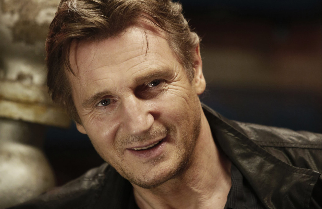 A portrait shot of Liam Neeson smiling