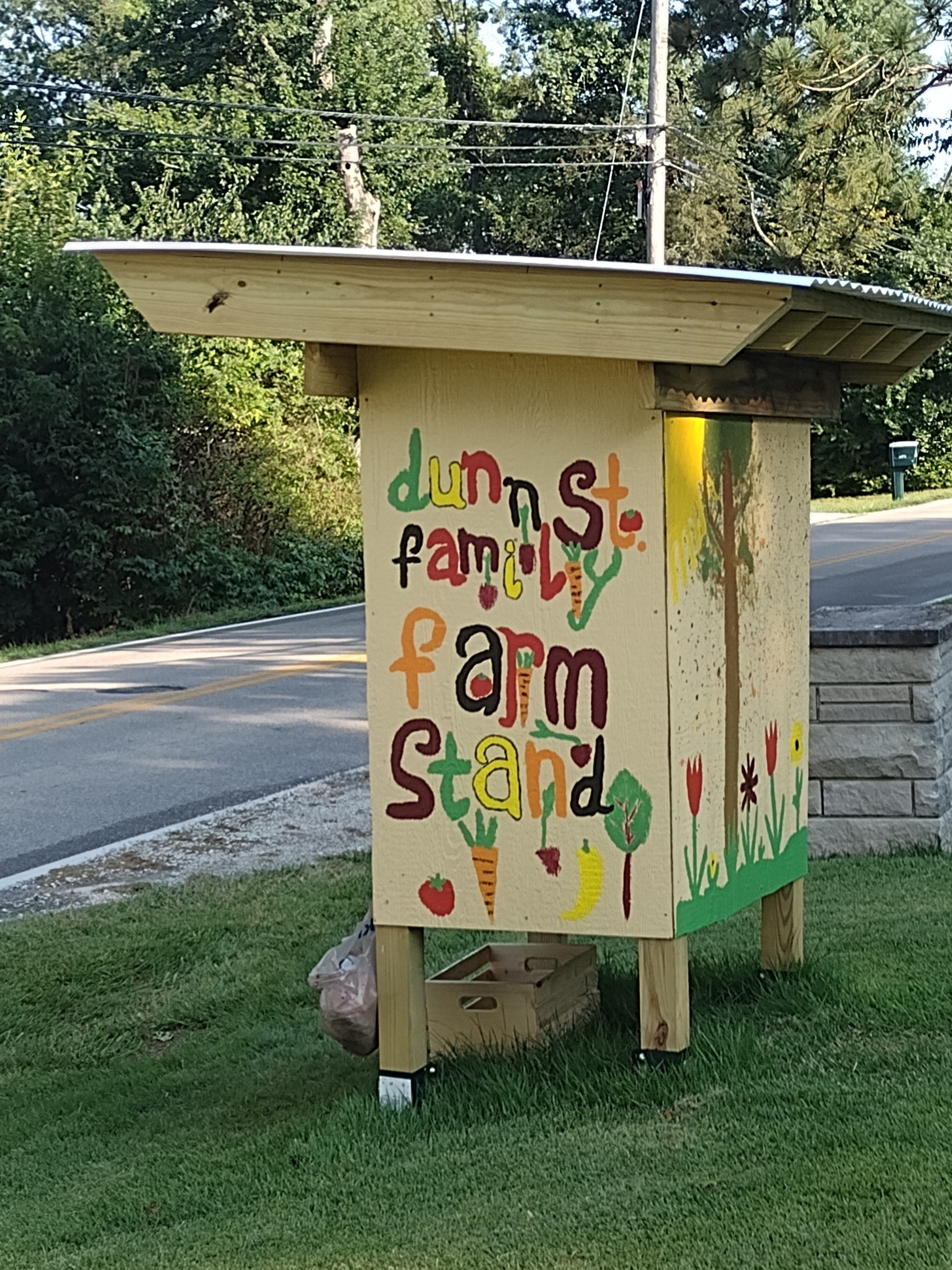 A roadside farm stand. It says "Dunn St. Family Farm Stand" on the side.